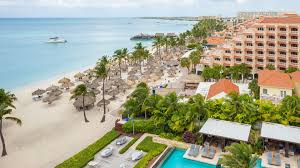 Hyatt Regency Aruba beachfront resort with pools, casino, and palm-lined grounds.