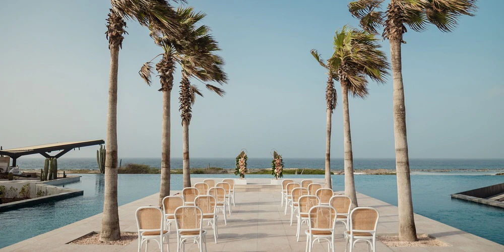 Infinity Pool wedding ceremony setup overlooking the ocean at Secrets Baby Beach Aruba