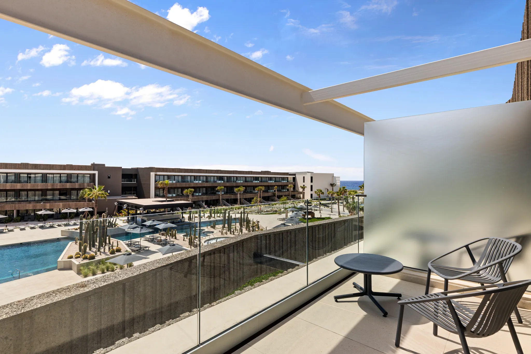 Private furnished balcony with pool view at Junior Suite Pool View in Secrets Baby Beach Aruba.