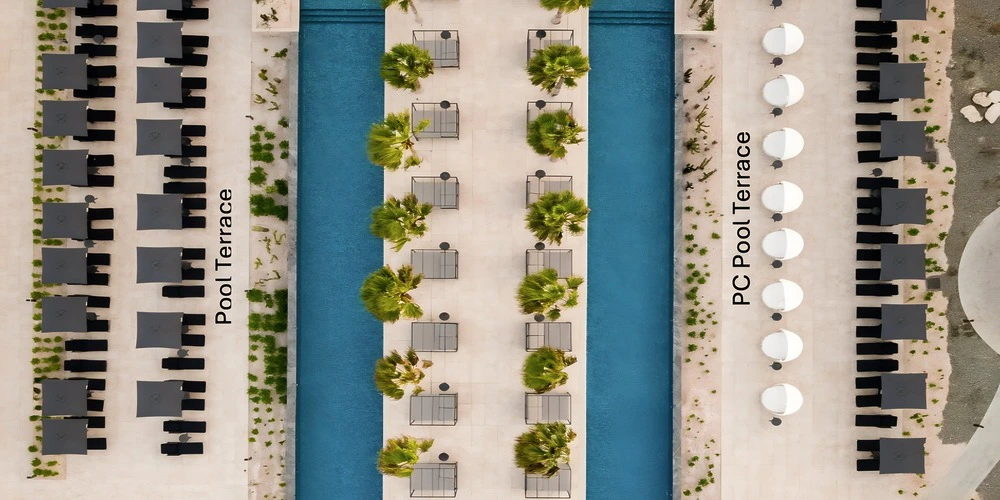 Pool Terrace aerial view with lounge cabanas at Secrets Baby Beach Aruba