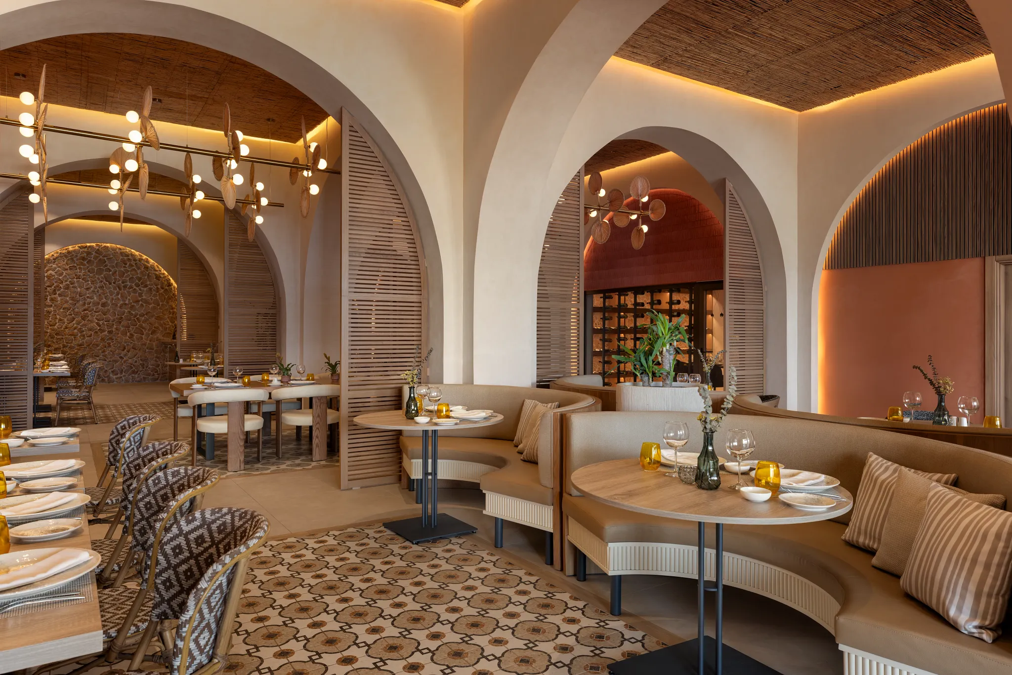 Portofino Italian restaurant at Secrets Baby Beach Aruba featuring elegant arched architecture, warm lighting, and intimate dining booths.