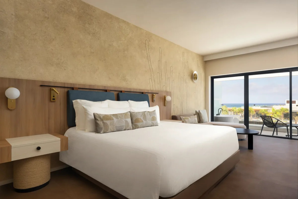 Preferred Club Junior Suite with king-size bed and private balcony at Secrets Baby Beach Aruba.